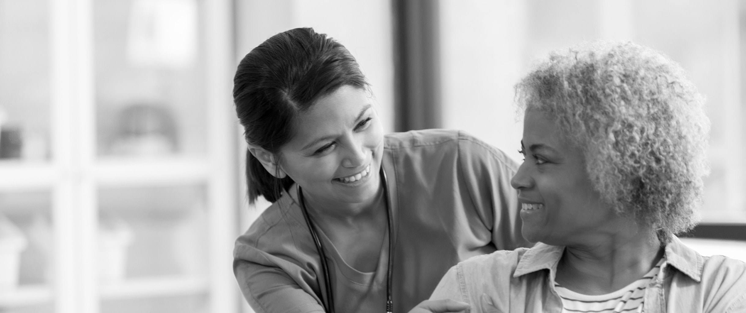 female nurse smiling with female patient